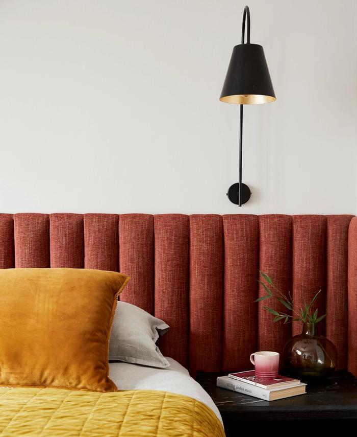 Maroon headboard with mustard bedspread