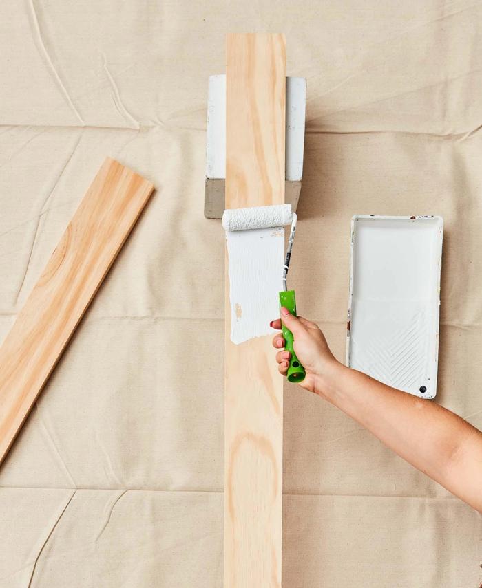 A wood block being painted with white Resene paint