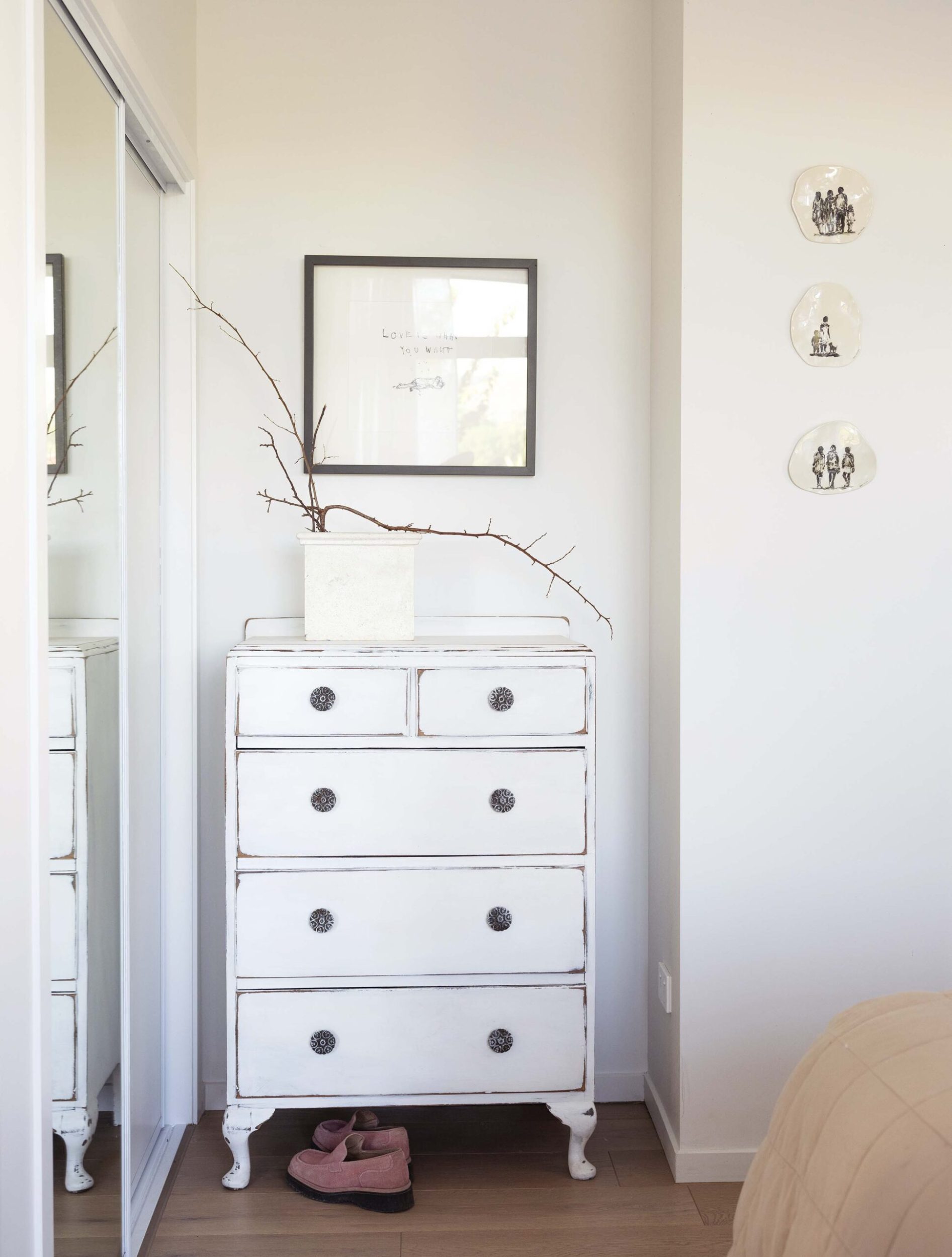 A white bedroom room with a white vintage cabinet