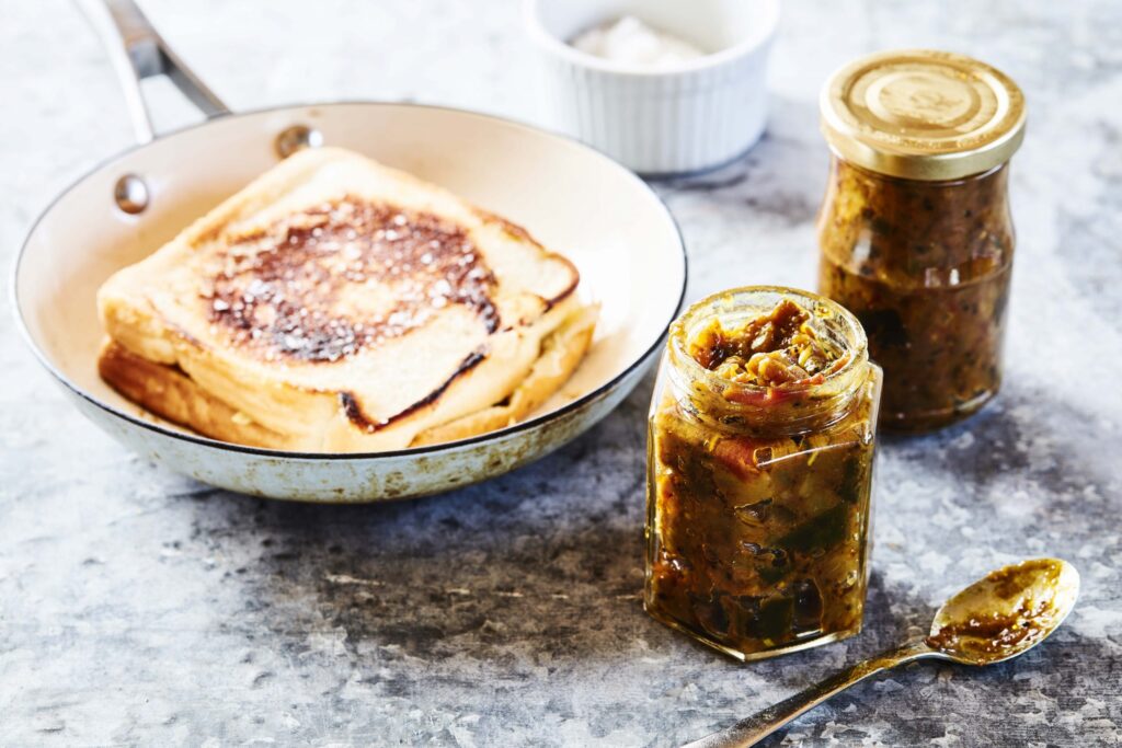 Spicy brinjal eggplant chutney in a jar and round plate
