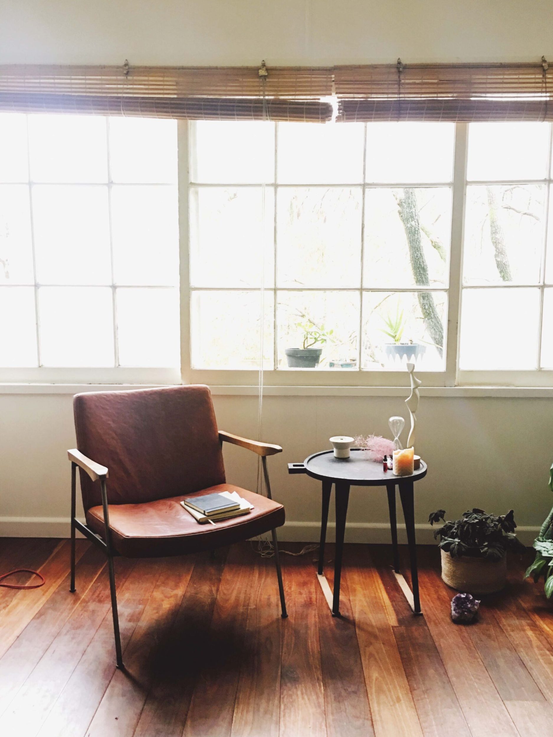 A chair and a table next to a window