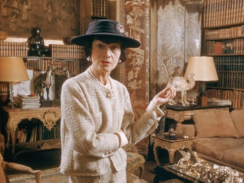 Coco Chanel wearing Chanel suit and black hat