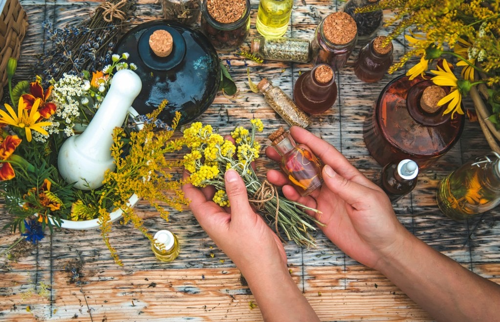 Woman with medicinal herbs and tinctures Selective focus