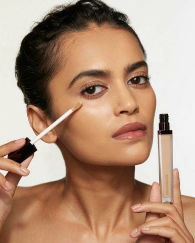 The Hourglass Vanish Airbrush Concealer shown on a model with a natural makeup look. 