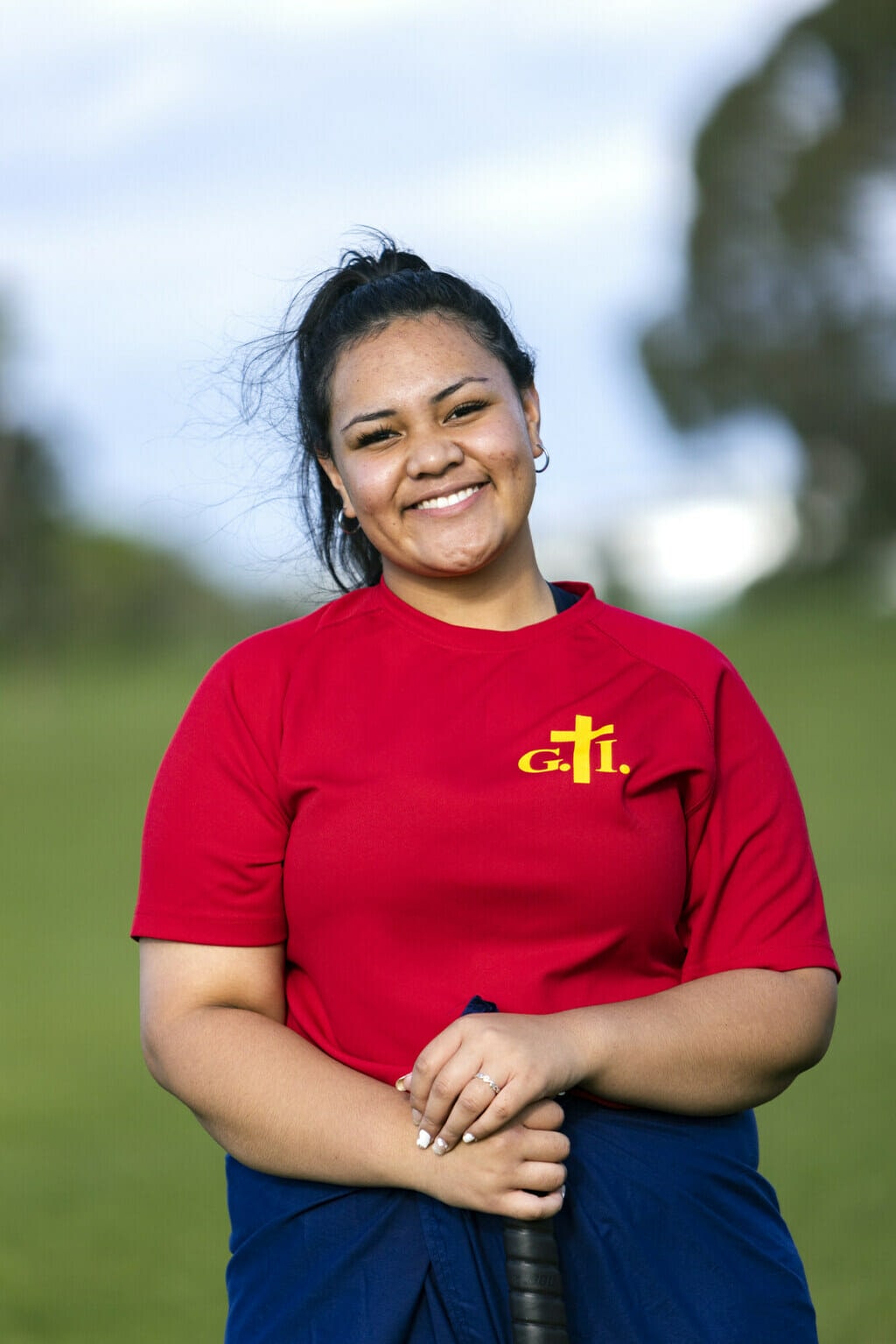 Telesia Tomafua standing with cricket bat in her hand.