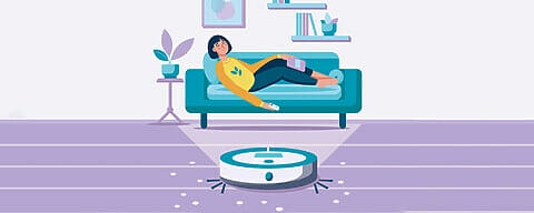 Young woman sleeping, relaxing on sofa and robot vacuum cleaner in the room. Modern wireless equipment for cleaning the apartment. Housework and technology concept.