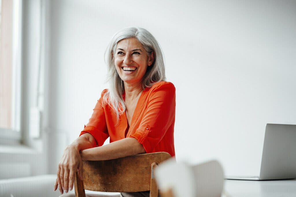 A working woman smiling at the office. 