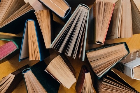 Group Of Books On Wooden Planks Background, Top View