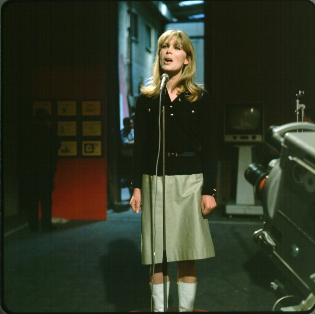 Nico standing at microphone. 