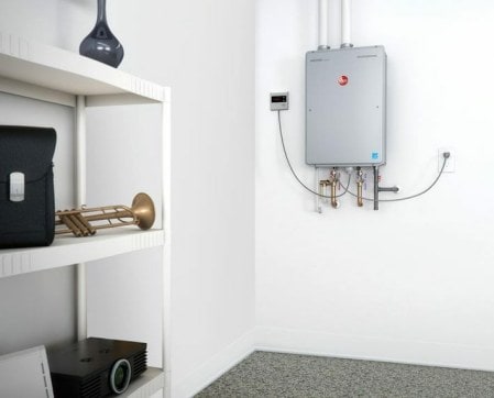 The eco-friendly tankless water heater mounted on a wall. 
