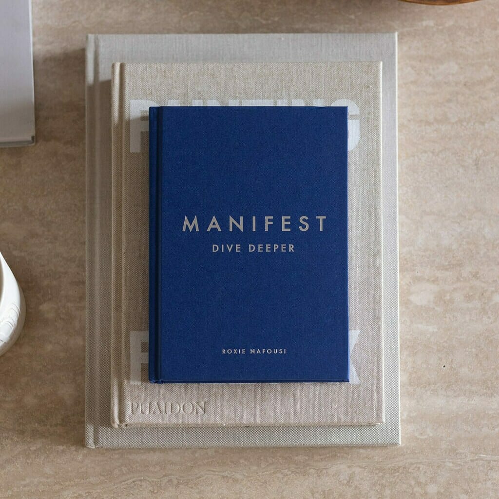 3 books stacked on top of each other on a white marble table