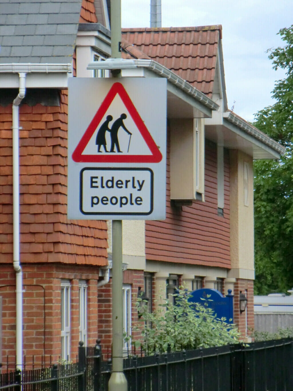 Road sign warning incoming drivers to drive with caution due to elderly people in the area. 