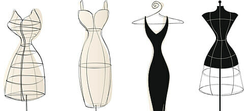 3 vintage-style dress forms and an elegant dress on a hanger.