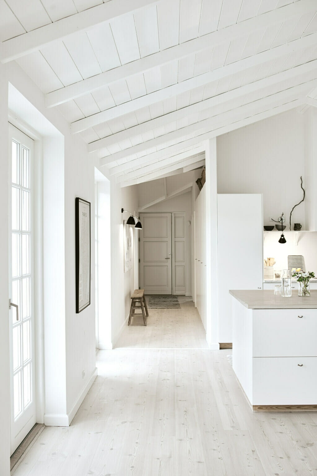 House with white walls, cabinetry and styling. 