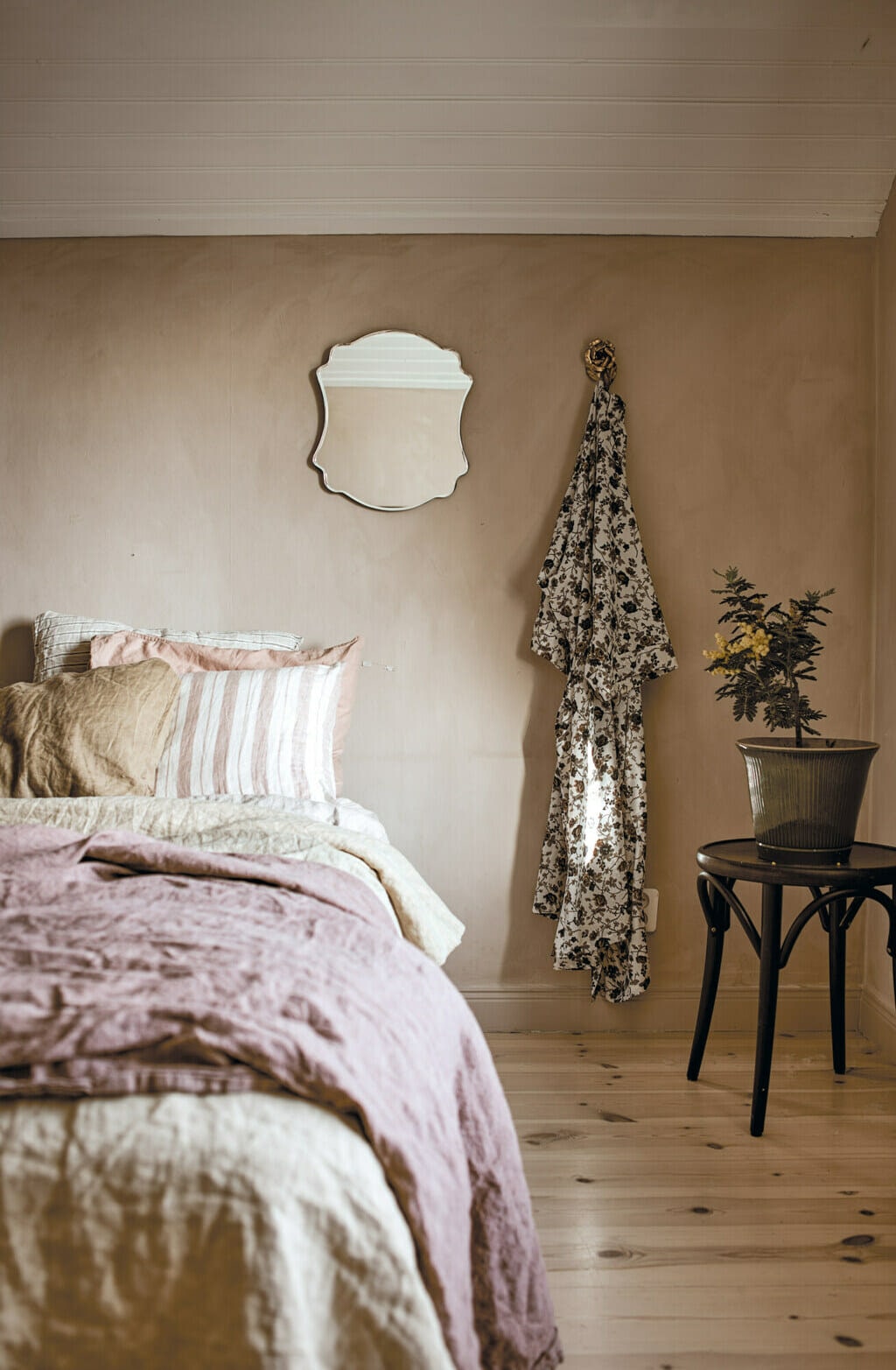 Image of bedroom with soft and natural bedding and styling. 