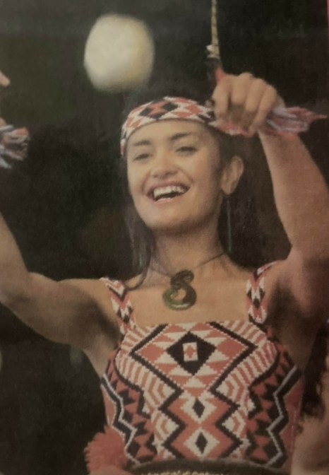 women in traditional maori costume performing the poi