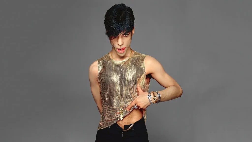 Prince wearing gold tank top 