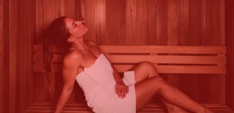 Women sitting in towel in an infared sauna