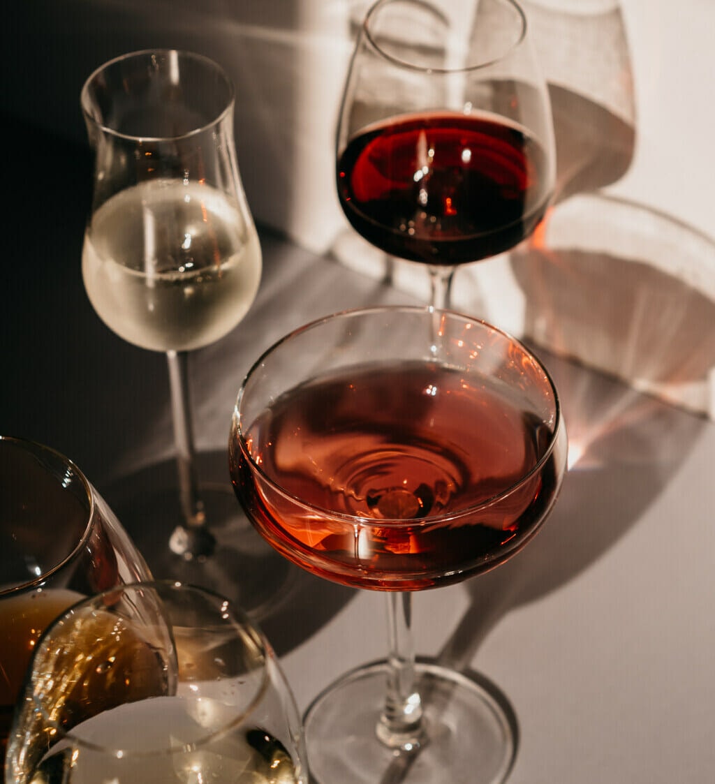 white, rose and red wine in glasses with silhouettes