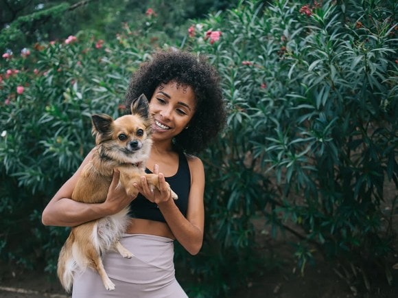 Woman with afro and fluffy dog