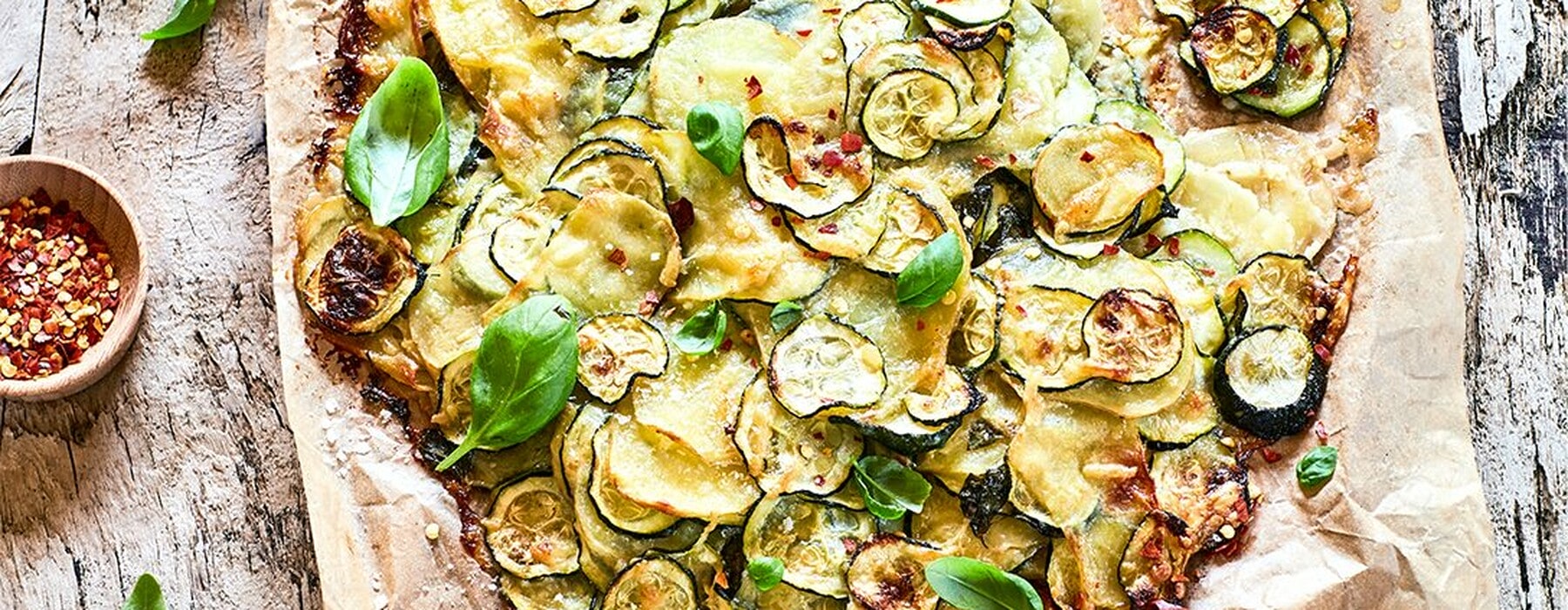Potato and courgette pie on a wooden table