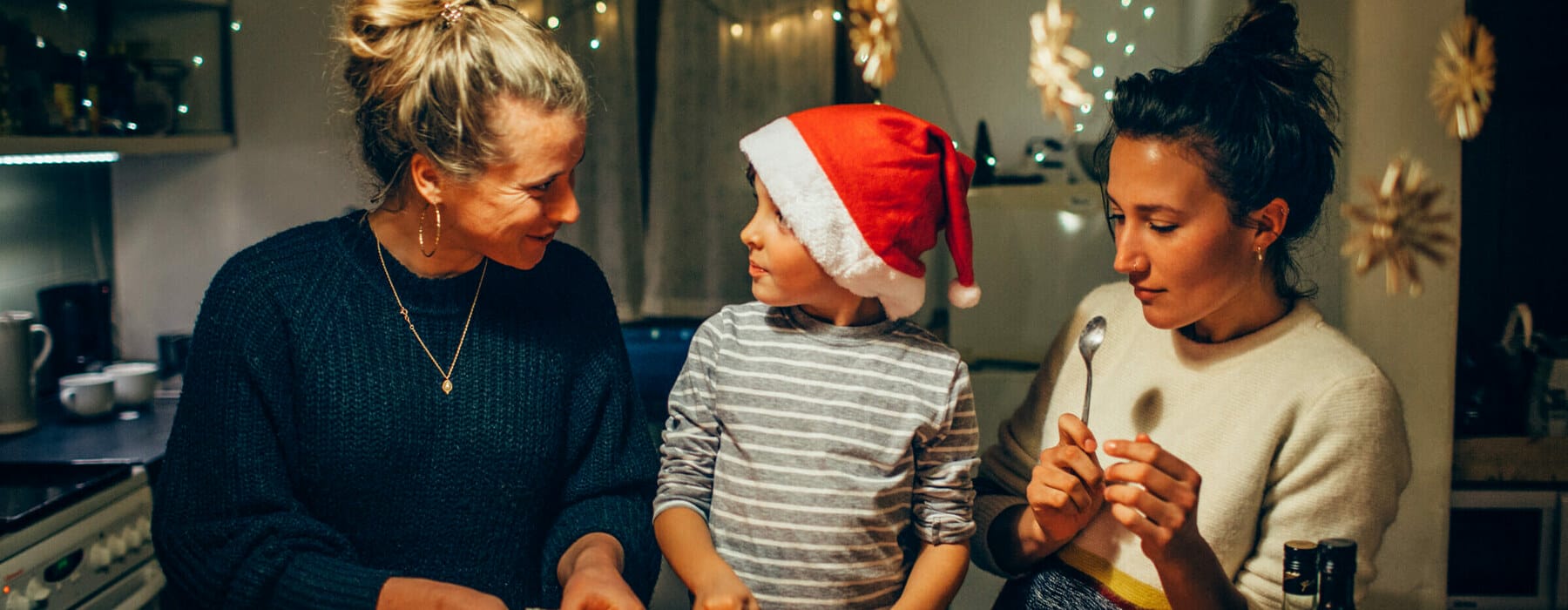 Two beautiful woman and young boy cooking holiday meal in kitchen / Algarve, Portugal. Part of a series.