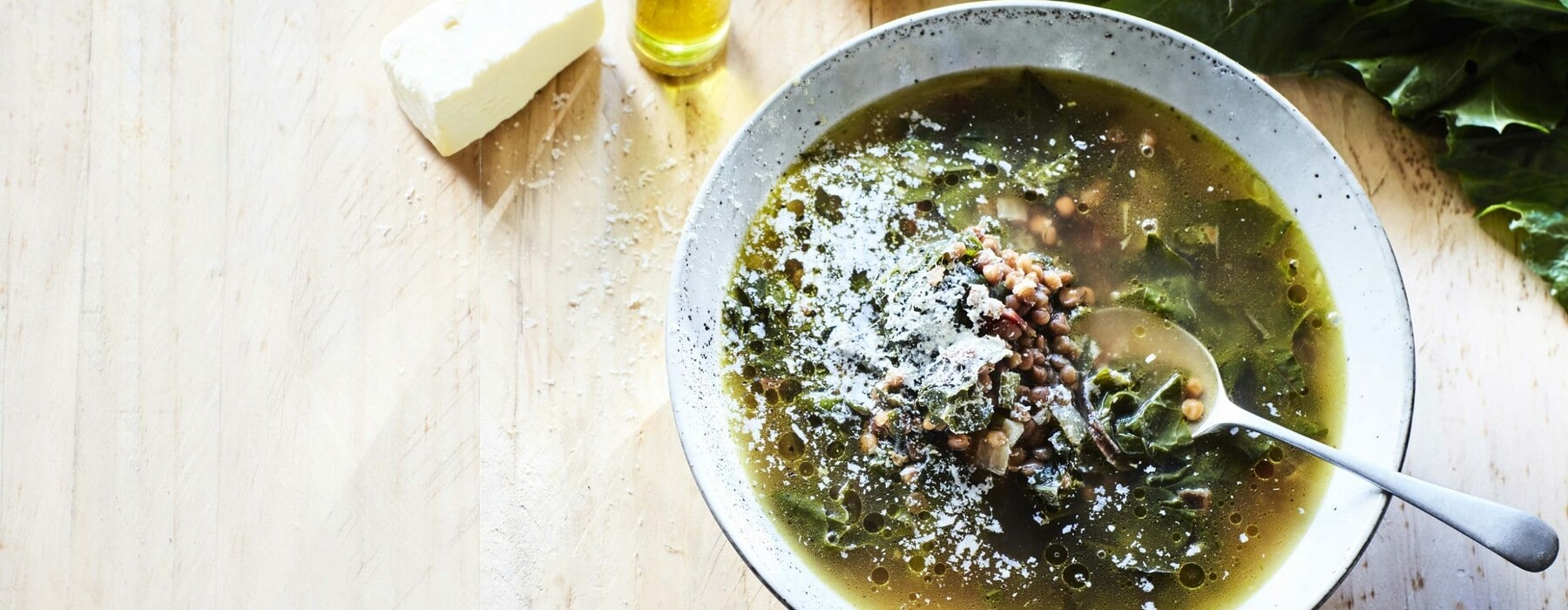 Greens, garlic, lemon and lentil soup in a bowl