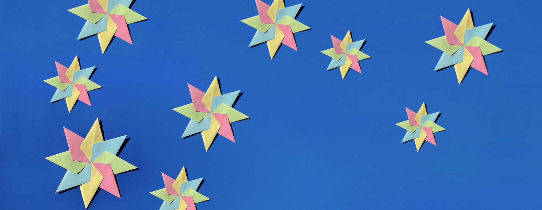Colourful paper stars against a blue background