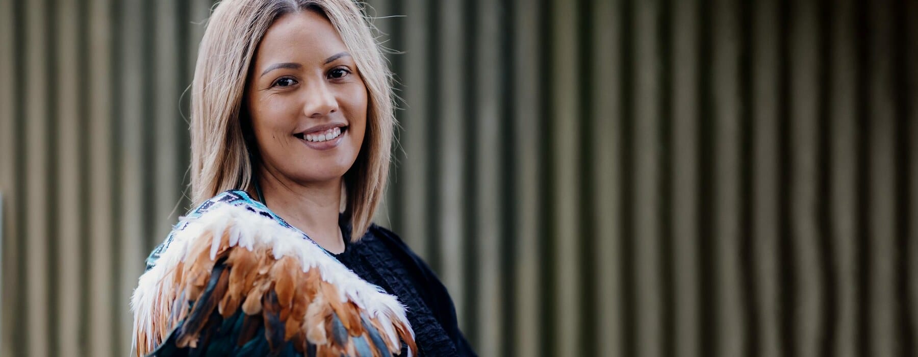 Hiria Faofua wearing a black top and white and brown korowai
