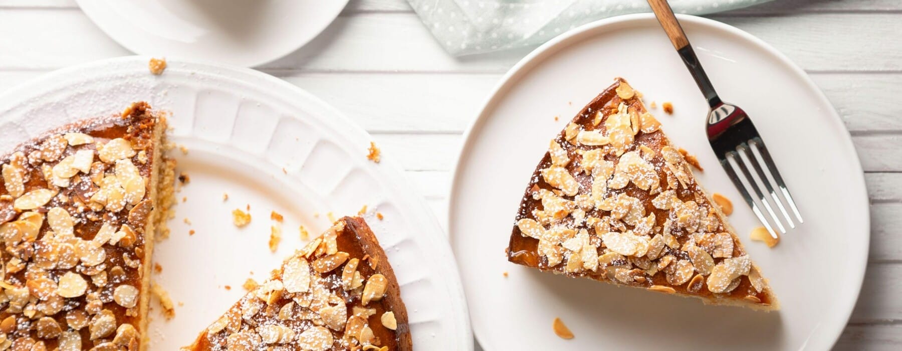 Seedy almond cake on a white table and white plates