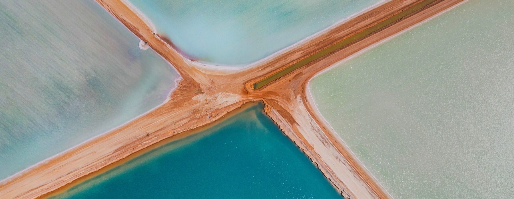 Aerial view of blue and green salt ponds in Western Australia