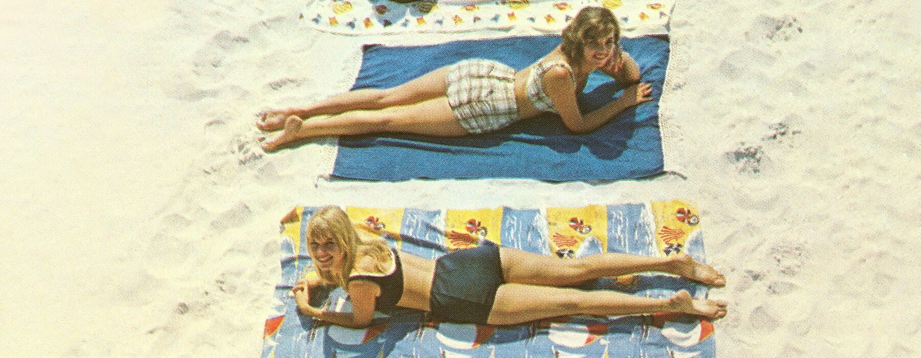 Vintage photo of four women lying on beach