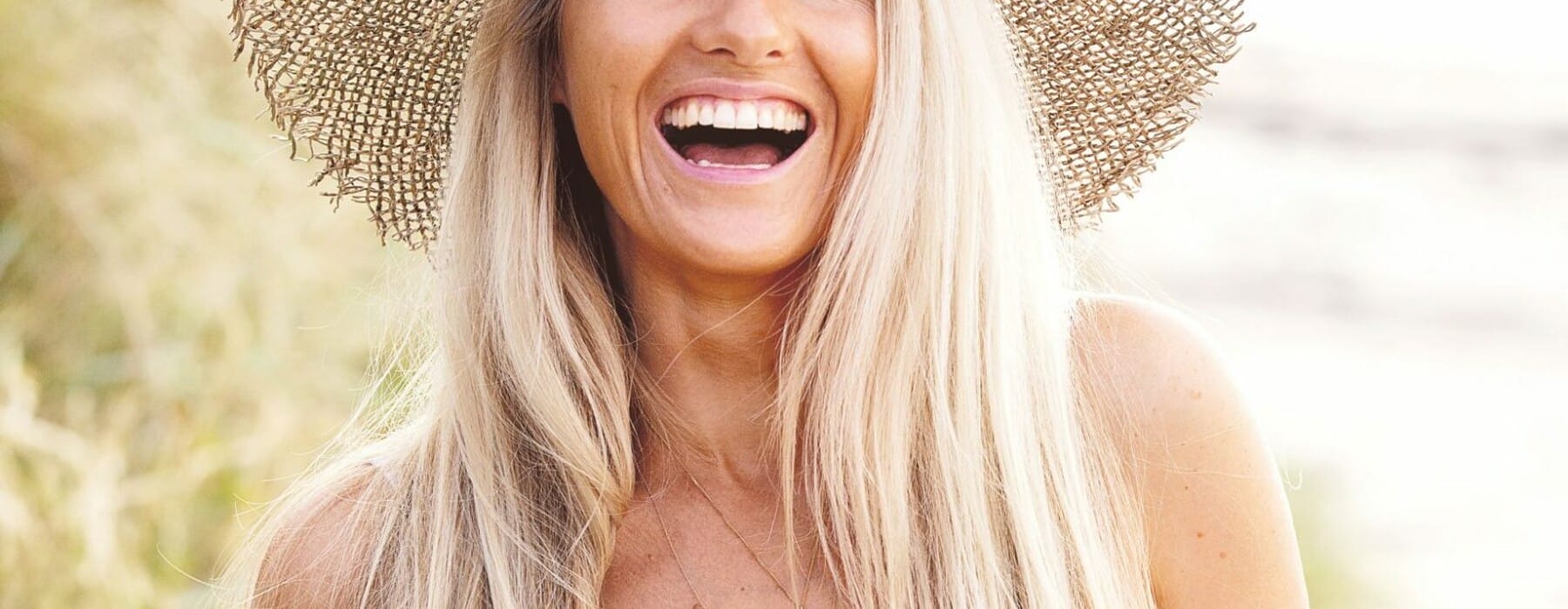 Sophie Steevens in straw hat holding half a watermelon