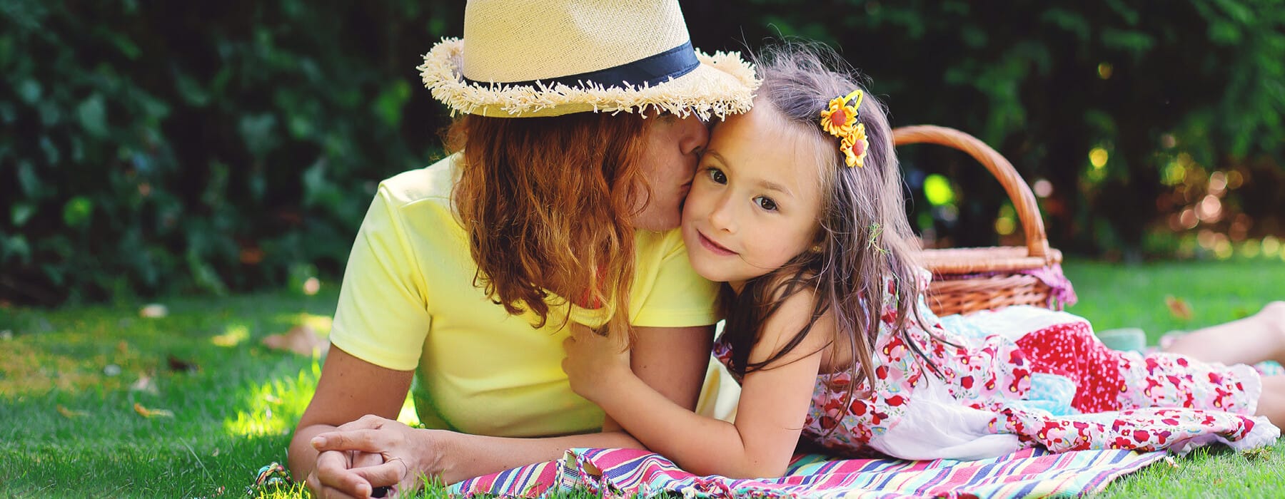 Mother and daughter lying on blanket