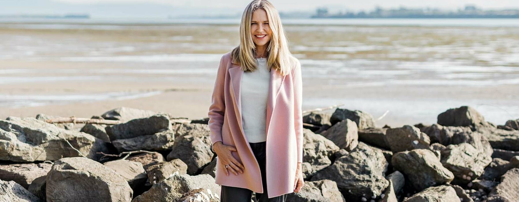 Sharon Hunter standing on a rocky beach