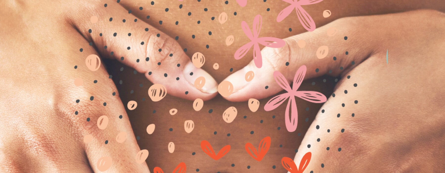 Close up of woman's hands holding stomach with drawings of hearts and flowers