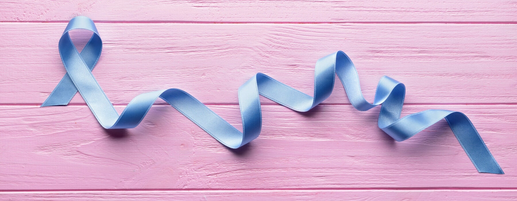 Blue,Ribbon,On,Color,Wooden,Table.,Cancer,Concept