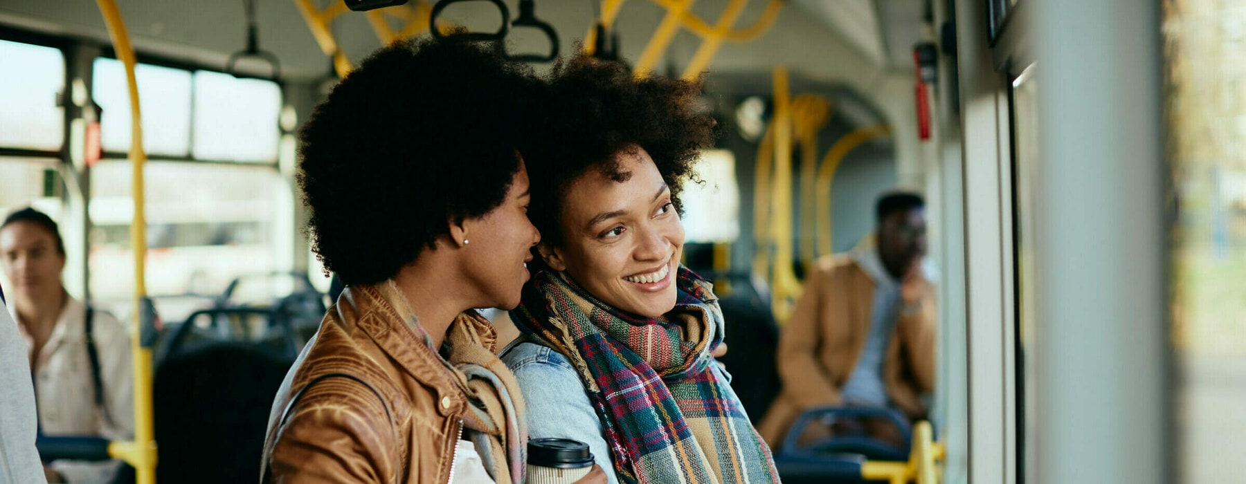 Happy,Black,Woman,Commuting,With,Her,Female,Friend,In,A