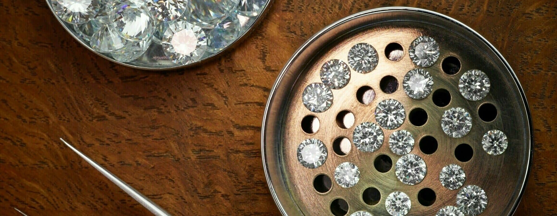 Loose,Polished,Round,Diamonds,In,Sieve,On,Dark,Wood,Background