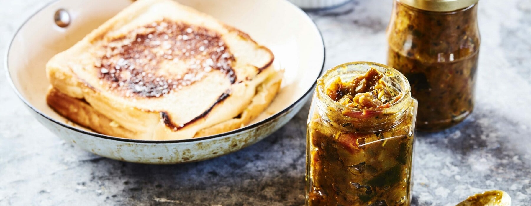 Spicy brinjal eggplant chutney in a jar and round plate