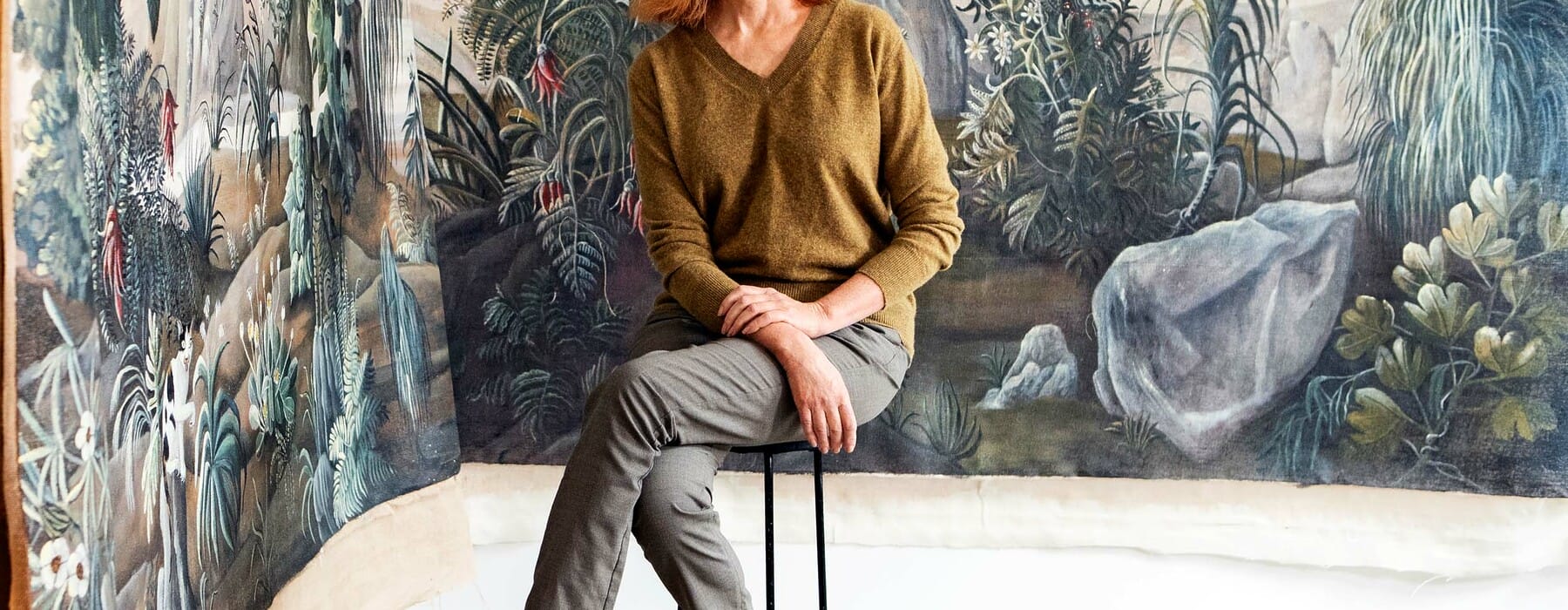 Kerrie Hughes sitting in front of her painted fabric