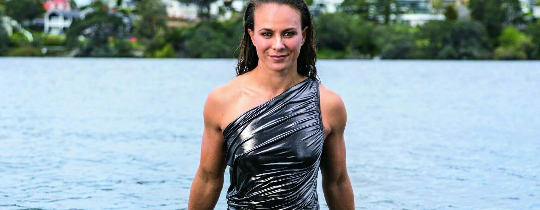 Lisa Carrington in a silver dress in a lake